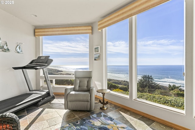 interior space featuring a water view and a beach view