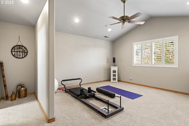 exercise room featuring vaulted ceiling, carpet, and ceiling fan