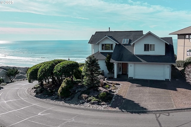 view of front of property with a water view and a garage