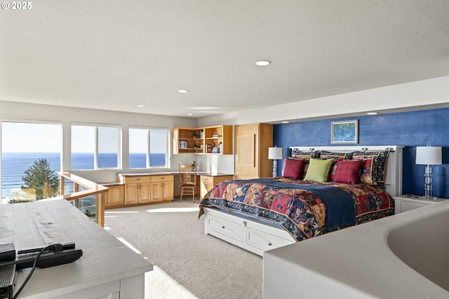 carpeted bedroom with a water view