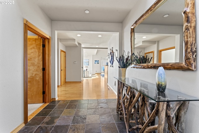 hallway with dark hardwood / wood-style flooring