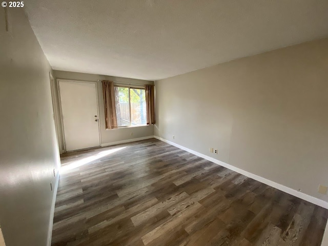 spare room with dark hardwood / wood-style flooring