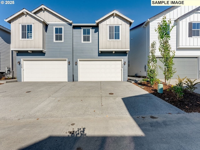 view of front of home with a garage, board and batten siding, and concrete driveway