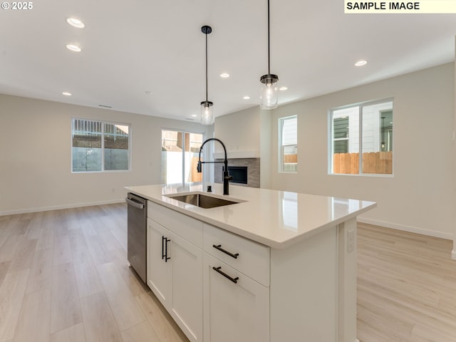 kitchen featuring plenty of natural light, light wood-style flooring, and a sink