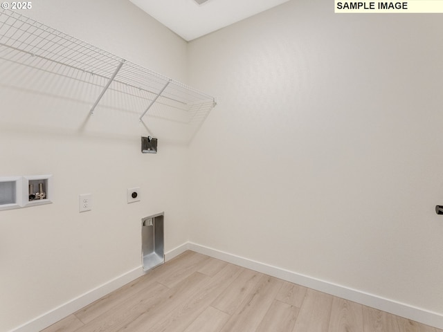 laundry area featuring hookup for a washing machine, laundry area, baseboards, light wood-style floors, and electric dryer hookup