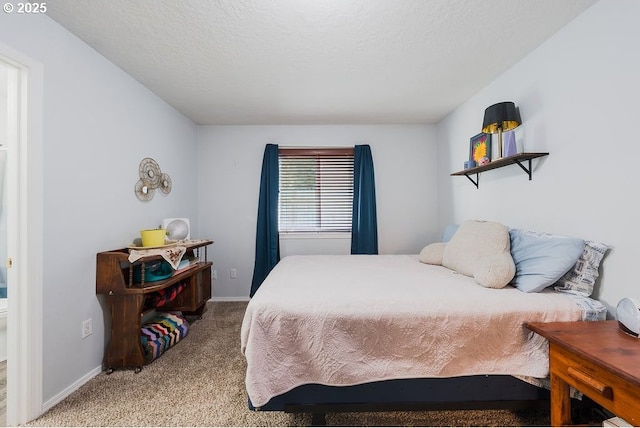 bedroom featuring light colored carpet and a textured ceiling