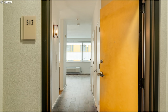 1125 NW 9th Ave Unit 512, Portland, OR 97209 - hall featuring dark wood-style flooring and a wall mounted air conditioner