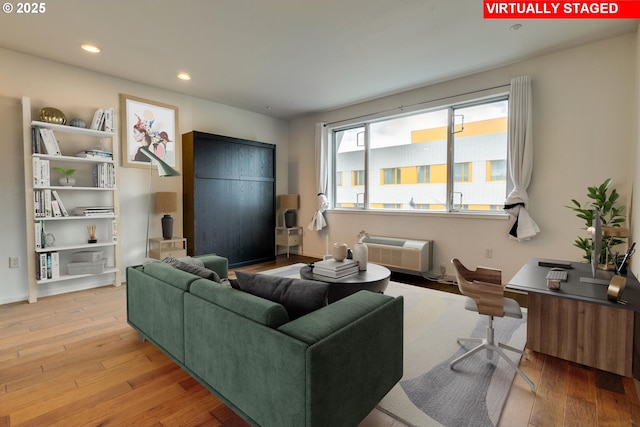 1125 NW 9th Ave Unit 512, Portland, OR 97209 - living area featuring wood-type flooring, recessed lighting, and a wall unit AC