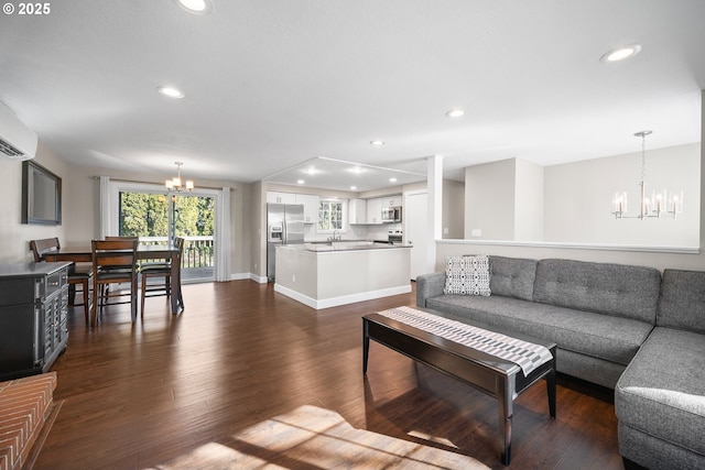 living room with an inviting chandelier and dark hardwood / wood-style floors