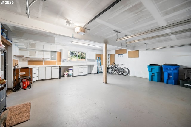 garage featuring electric panel and a garage door opener