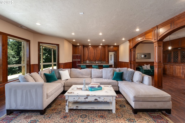 9684 Ankeny Crest Ln S, Salem, OR 97306 - living room with a wainscoted wall, a textured ceiling, decorative columns, wood finished floors, and recessed lighting