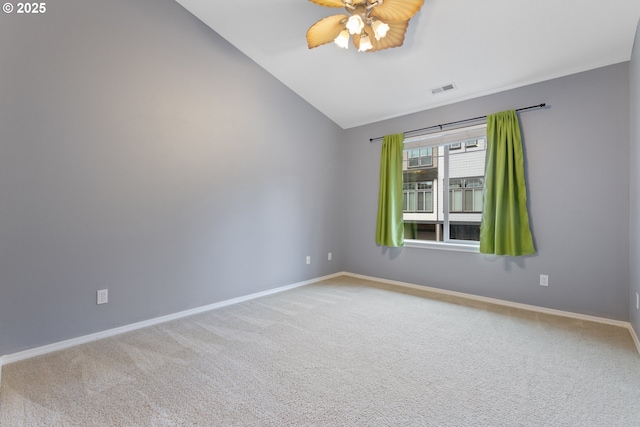 spare room featuring visible vents, carpet flooring, baseboards, and lofted ceiling