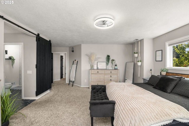 8028 SE 108th Ave, Portland, OR 97266 - carpeted bedroom featuring baseboards, a textured ceiling, a barn door, and connected bathroom