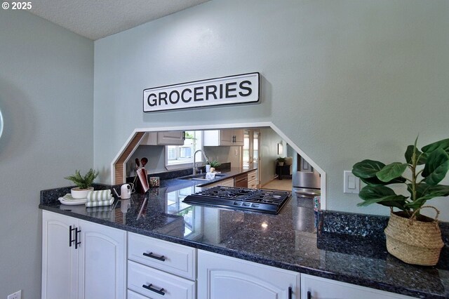 bar featuring a sink and gas stovetop