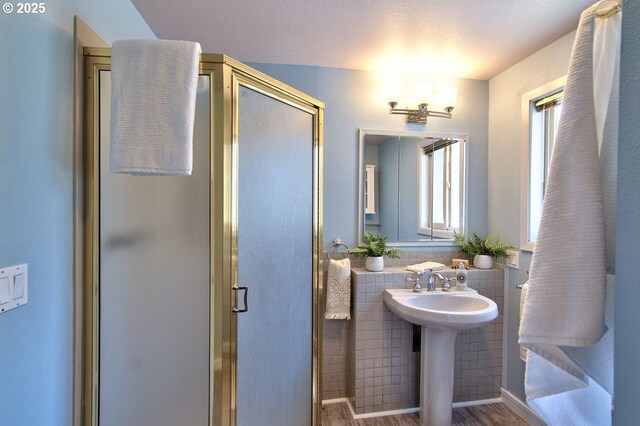 full bath with a sink and a stall shower