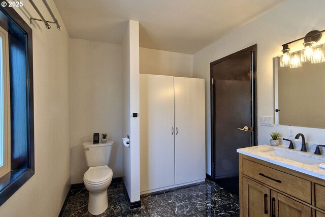 bathroom with vanity, marble finish floor, and toilet