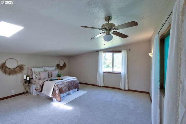 bedroom with carpet floors, a textured ceiling, vaulted ceiling, and ceiling fan