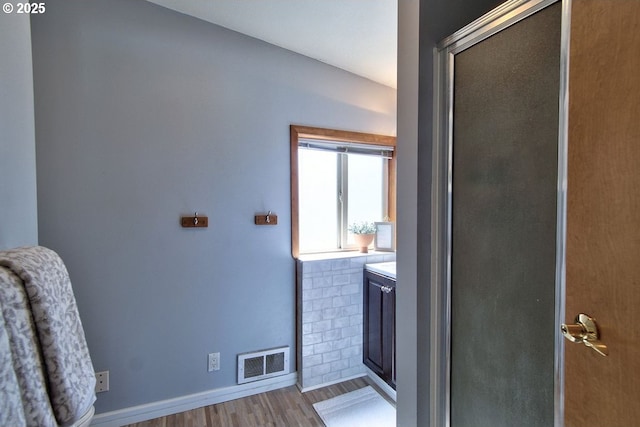 full bathroom with visible vents, baseboards, and wood finished floors