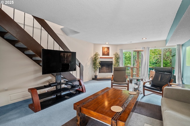 1659 NW Bridgeway Ln, Beaverton, OR 97006 - living area with carpet floors, a textured ceiling, a fireplace with raised hearth, stairway, and recessed lighting