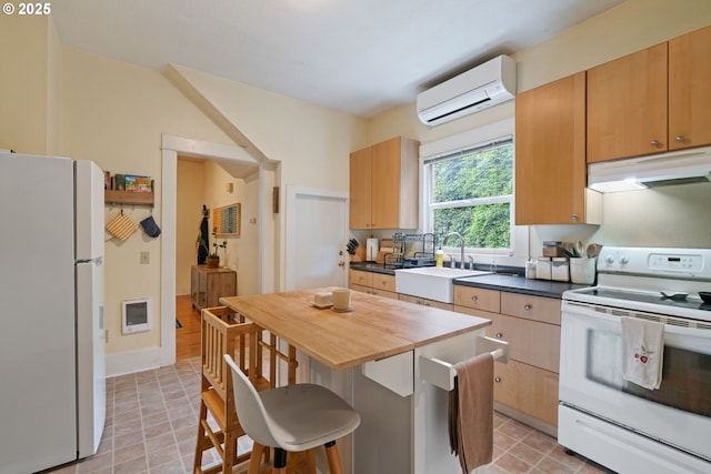 11151117 N Beech St, Portland, OR 97227 - kitchen with white appliances, under cabinet range hood, a wall mounted AC, a kitchen bar, and heating unit