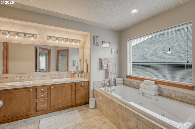 2459 SW Sandlewood Ln, Gresham, OR 97080 - full bathroom featuring a jetted tub, double vanity, a textured ceiling, tile patterned floors, and a shower