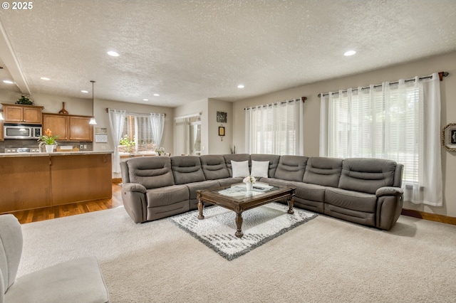 2459 SW Sandlewood Ln, Gresham, OR 97080 - living room featuring a textured ceiling, recessed lighting, and light wood finished floors