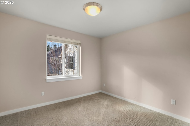 carpeted spare room with baseboards