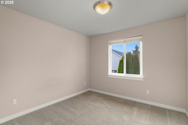 unfurnished room featuring baseboards and light colored carpet