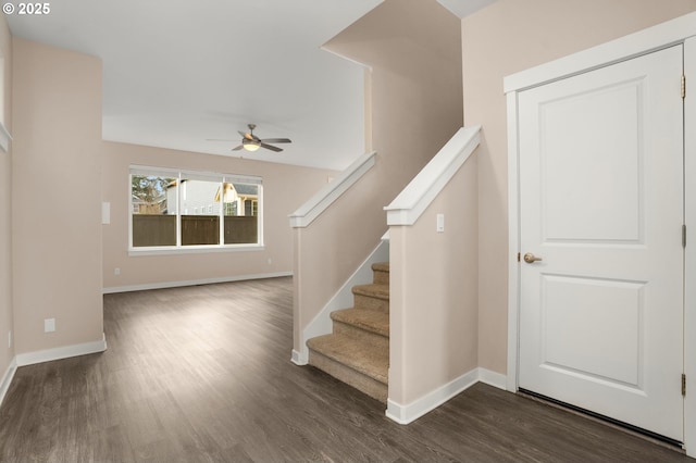 stairs featuring ceiling fan, baseboards, and wood finished floors