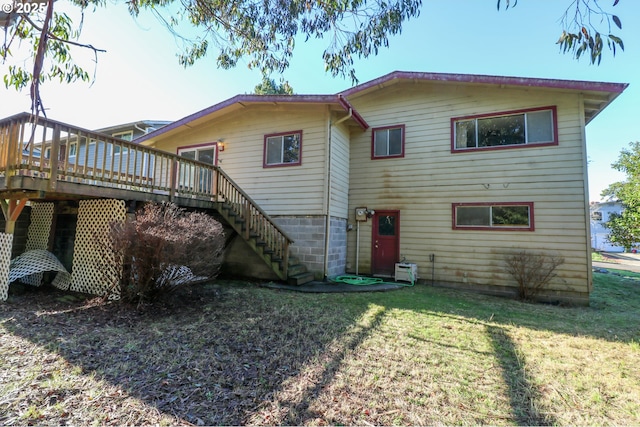 back of house with a lawn and a deck