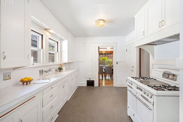 kitchen featuring white cabinetry, a sink, light countertops, and gas range gas stove