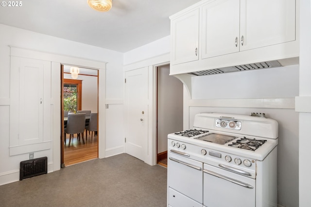 kitchen with white cabinets, baseboards, visible vents, and double oven range