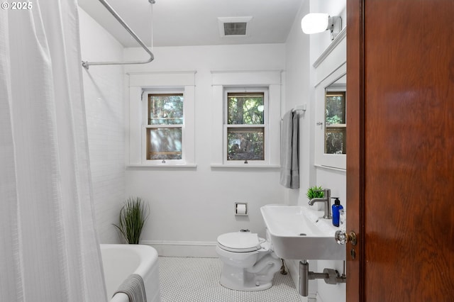 bathroom with tile patterned floors, a sink, toilet, baseboards, and visible vents