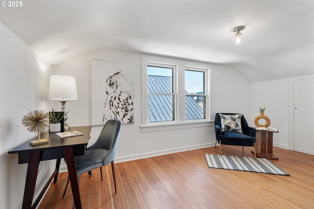 office area featuring vaulted ceiling, hardwood / wood-style floors, and baseboards