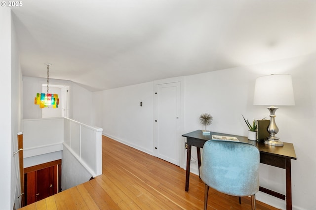 interior space with baseboards and wood finished floors
