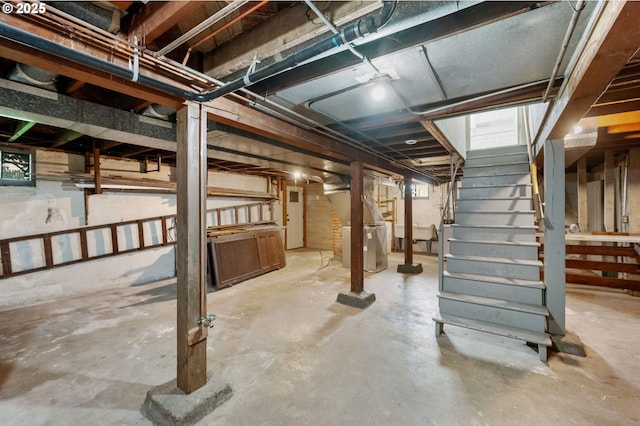 unfinished basement featuring stairway
