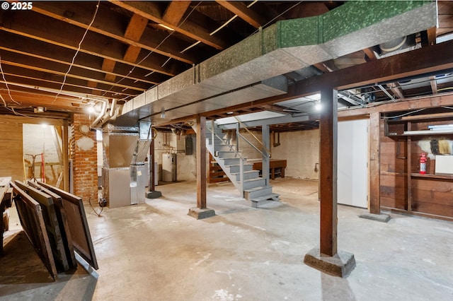 unfinished basement with electric panel, heating unit, water heater, and stairs