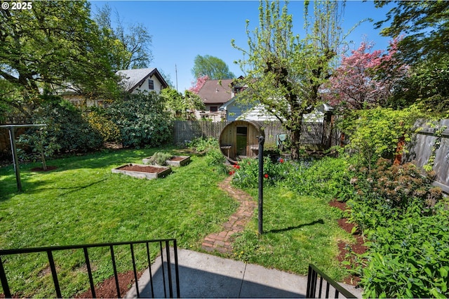 view of yard featuring a fenced backyard and a vegetable garden