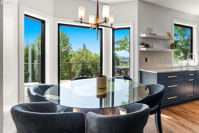 dining space with an inviting chandelier and wood finished floors