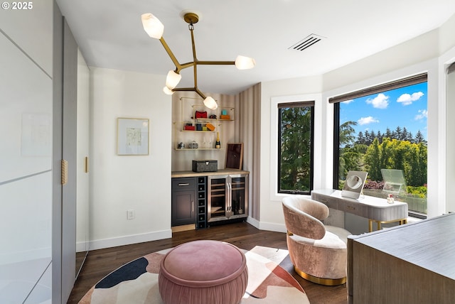 bar featuring visible vents, a wealth of natural light, beverage cooler, and a bar