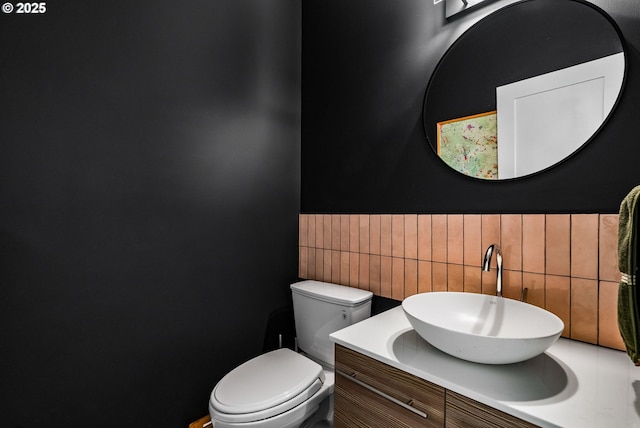 half bath featuring vanity and toilet