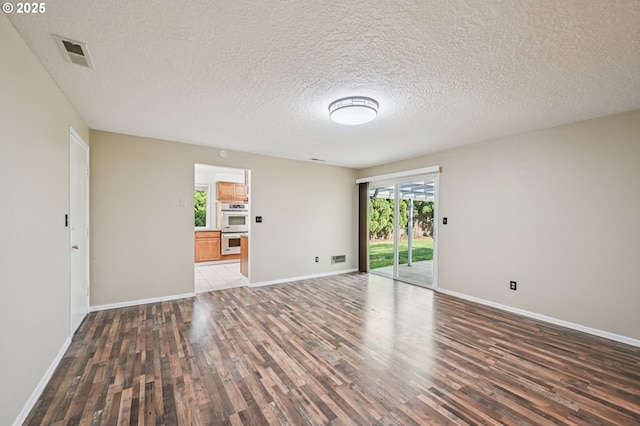 1631 N Clark St, Cornelius, OR 97113 - unfurnished living room featuring wood finished floors and a textured ceiling