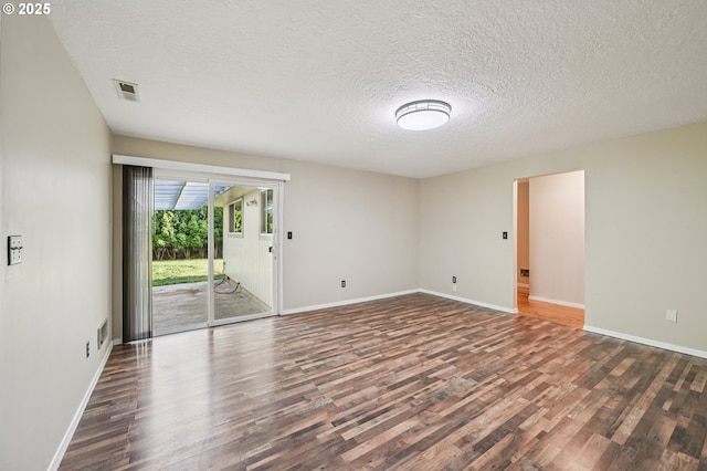 1631 N Clark St, Cornelius, OR 97113 - empty room featuring dark wood-type flooring and a textured ceiling