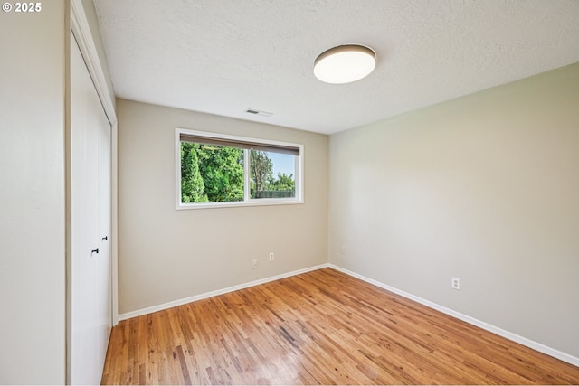 1631 N Clark St, Cornelius, OR 97113 - unfurnished bedroom featuring a closet, light wood-style flooring, and a textured ceiling