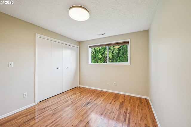 1631 N Clark St, Cornelius, OR 97113 - unfurnished bedroom with wood finished floors, a closet, and a textured ceiling
