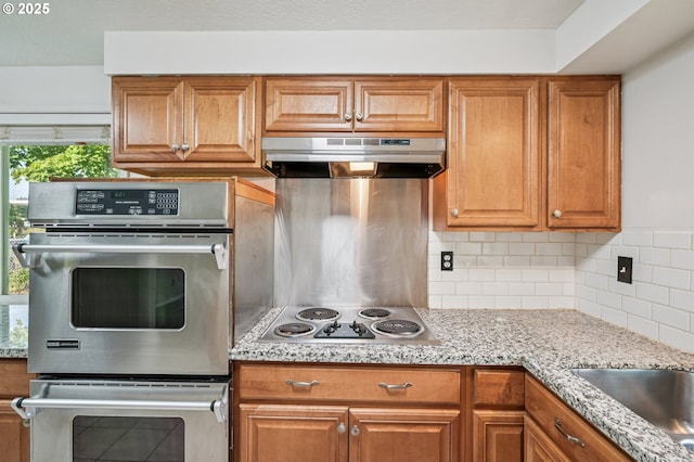 1631 N Clark St, Cornelius, OR 97113 - kitchen featuring under cabinet range hood, stainless steel appliances, plenty of natural light, and backsplash