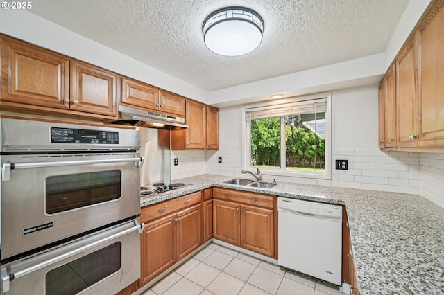 1631 N Clark St, Cornelius, OR 97113 - kitchen with white dishwasher, double oven, under cabinet range hood, a textured ceiling, and electric stovetop