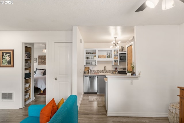 7538 SW Barnes Rd Unit H, Portland, OR 97225 - kitchen featuring appliances with stainless steel finishes, wood finished floors, a sink, and open shelves