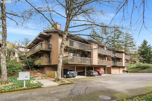 7538 SW Barnes Rd Unit H, Portland, OR 97225 - view of property featuring covered and uncovered parking