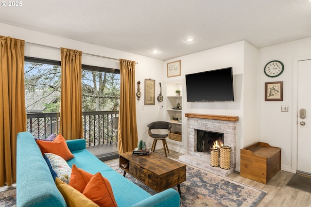 7538 SW Barnes Rd Unit H, Portland, OR 97225 - living area with wood finished floors, a fireplace, baseboards, recessed lighting, and built in features